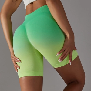 Macro view of seamless high-waisted yoga shorts with gradient green and yellow knit texture