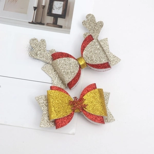Close-up of glitter Christmas hair clips with reindeer antlers and snowflake details