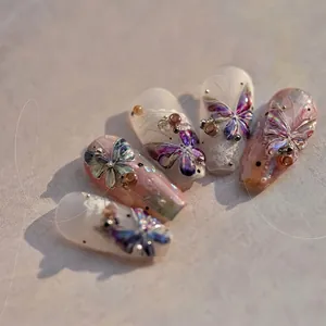 Detail of jelly nail stickers featuring 3D laser butterflies and intricate lace patterns
