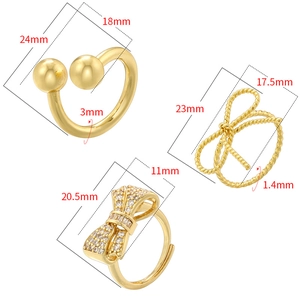Three gold creative rings with twist bow and ball designs on white background