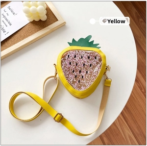 Detail of yellow strawberry shaped jelly bag featuring floating star sequins and green leaves