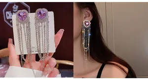 Close-up of purple heart crystal earrings with dangling silver chain tassels and S925 studs