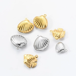 Detailed macro of gold and silver hollow shell and fish pendants for DIY jewelry