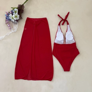 Red two-piece bikini set with a halter neckline swimsuit and a sheer mesh beach sarong