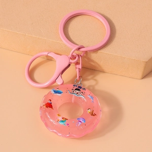 Detailed shot of pink donut keychain with glitter, ocean patterns and pink metal ring