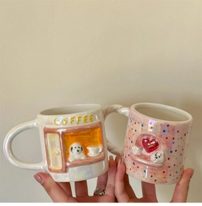Detail of cute 3D ceramic mugs with pearlescent finish, puppy and heart embossed motifs