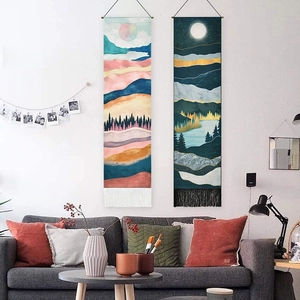 Mountain landscape tapestries with tassel design shown in a cozy living room setting