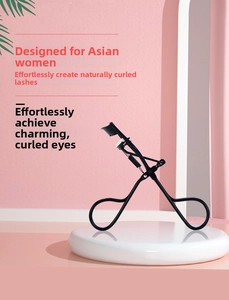 Detail of 3D eyelash curler with black metal frame and white silicone pad on pink background