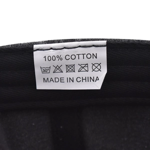 Close-up of 100% cotton wash label and inner stitching on black baseball cap