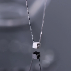 Titanium steel cube necklace with matte brushed finish on a minimalist box chain