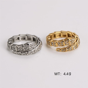 Snake wrap ring in gold and silver steel with crystal pavé on white background