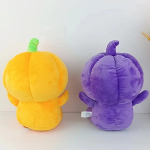 Detail of plush Halloween pumpkins in orange and purple with soft stuffed texture