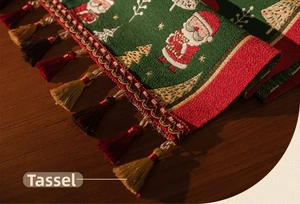 Detail of Christmas table runner with festive jacquard patterns and decorative tassels