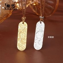 Detailed view of double-sided mahjong pendant necklace in gold and silver finish
