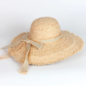 Wide brim raffia sun hat for women with bow tie and frayed edges for beach vacations