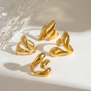 Macro view of four irregular fluid water drop rings in 18K gold stainless steel finish