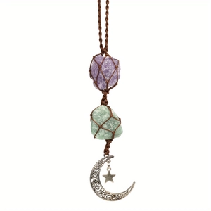 Close-up of handmade amethyst crystal moon hanger with woven rope and silver star pendant