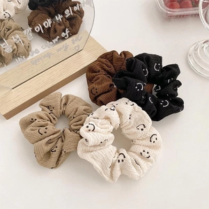 Corduroy scrunchies set with smiley face in brown, black, beige, and cream colors