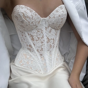 Sultry white lace corset top with floral embroidery and structuring boning for women