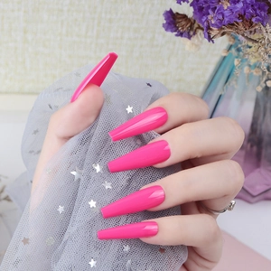 Detail of long coffin press-on nails in glossy peach pink with smooth UV finish