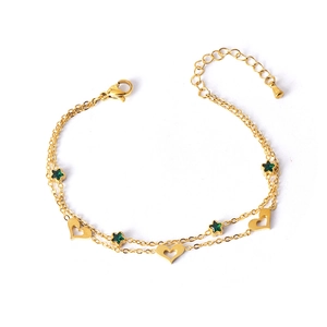 Gold double-layer bracelet with green star gem and hollow heart pendant on white background