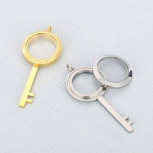 Detailed view of openable gold and silver stainless steel key-shaped locket pendants