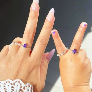 Détail des bagues ajustables avec gemmes violettes et perles pour maman et enfant