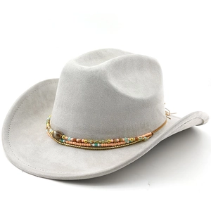 Detailed close-up of bohemian colorful beaded band on a beige suede western cowboy hat