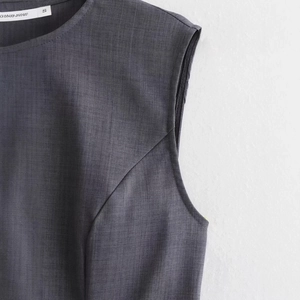 Women's sleeveless grey high waist dress featuring round neck and pleated texture details