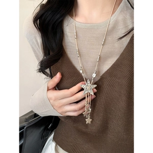 Detailed view of bohemian star pendant necklace on model with vintage silver finish