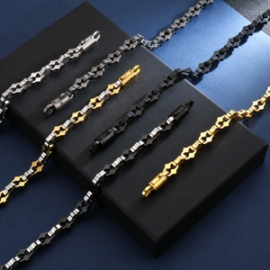 Detailed macro view of hip hop style geometric chain necklaces in silver and gold tones