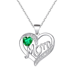 Macro detail of silver heart necklace with green stone and Mom engraving for Mother's Day