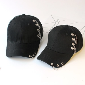 Punk style black cotton baseball caps with metal rings and chains on white background