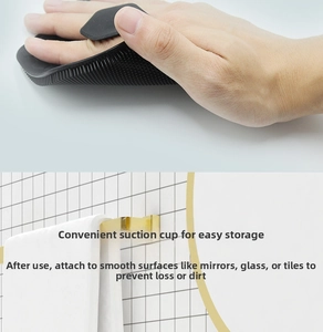 Detail of flexible black silicone body brush with suction cup hook for wall storage
