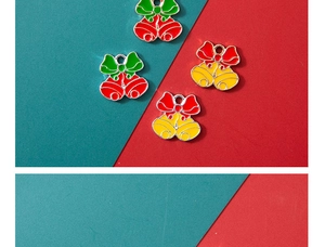 Detail of DIY Christmas bell charms in red and yellow alloy with decorative bow accents
