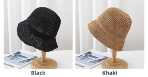 Detail of hand-woven straw bucket hats in black and khaki with exquisite knit texture