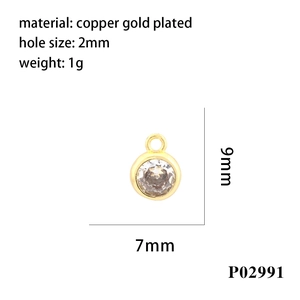 Detail view of 7mm gold-plated copper birthstone charm with clear cubic zirconia
