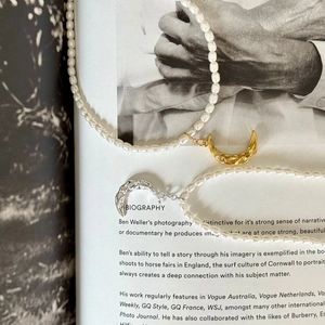 Elegantly textured gold and silver moon pendant pearl necklaces on fashion magazine