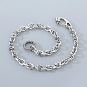 Close-up of silver punk wolf head clasp and thick metal chain for trousers