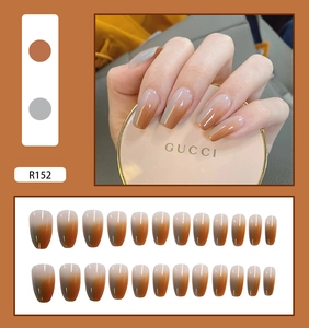 Macro detail of R152 press-on nails featuring brown and grey gradient glossy finish