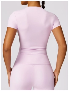 Rear view of light pink high-stretch yoga set with slim fit tee and high waist leggings