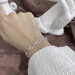 Elegant S925 sterling silver chain bracelet with irregular links on model wrist