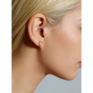 Elegant gold crescent moon stud earrings with zircon stones worn by a female model
