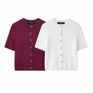Detail of knit cardigans featuring decorative silver bow buttons in red and white