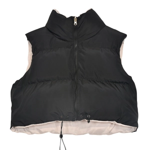 Detail of cropped puffer vest featuring high stand collar and two-tone color block design