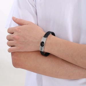 Detail of double-layer leather bracelet with silver curved plate and black stone inlay