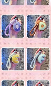 Detail of colorful leather letter keychains with matching lanyards and matte black rings