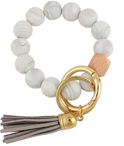 Detail of beaded keychain bracelet with grey marble silicone beads and leather tassel