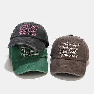 Detailed texture of washed cotton baseball caps with embroidered wake up slogan
