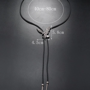 Detail of silver eagle bolo tie pendant with adjustable woven leather rope length